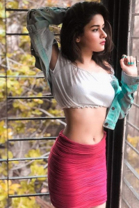 Avneet Kaur making hot pose in white top and pink skirt
