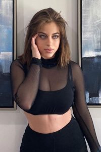 Baby Ariel wearing black top with net sleeves and black trouser
