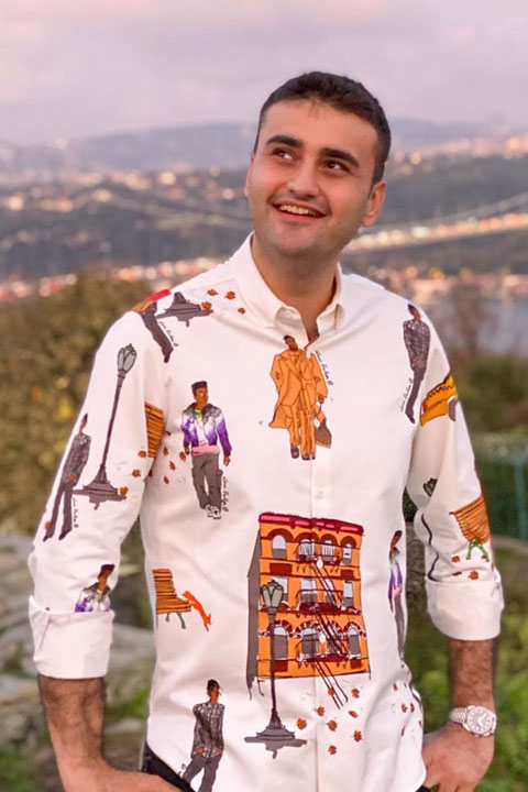 Burak Özdemir wearing white shirt with beautiful scenery in background