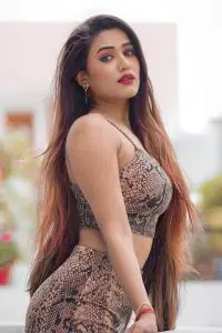 Garima Chaurasia is looking stunning in red lipstick and open hair.