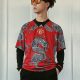 Jin Jun wearing red dragon shirt and black Adidas trousers.