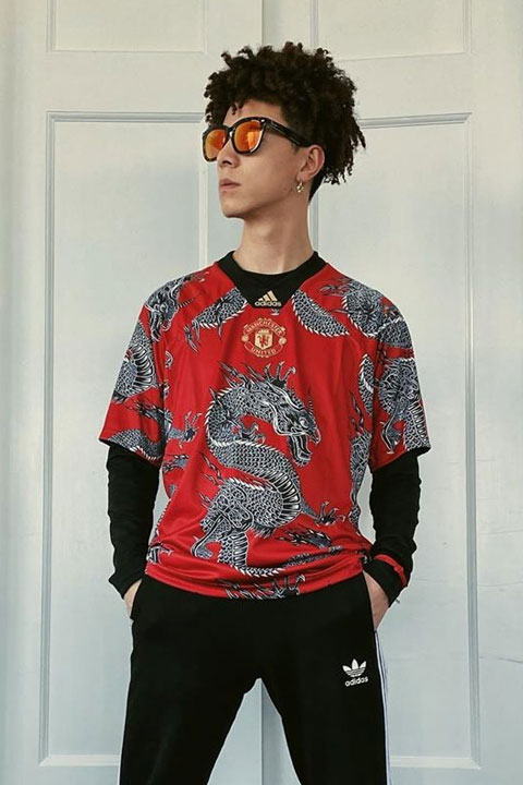 Jin Jun wearing red dragon shirt and black Adidas trousers.