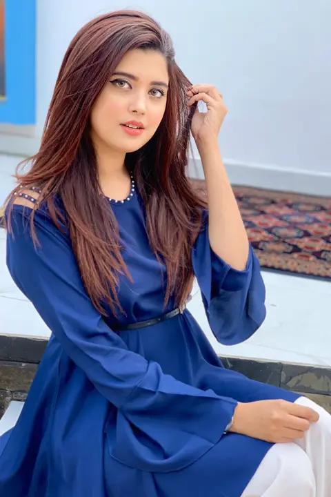 Kanwal Aftab wearing blue dress with her shoulders exposed