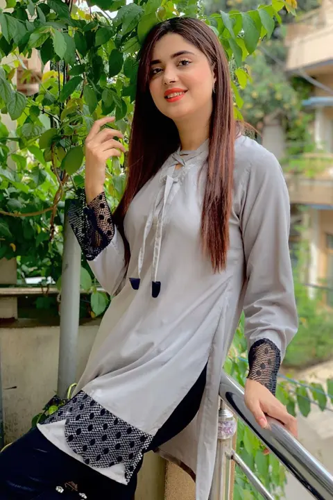 Kanwal Aftab wearing grey dress and smiling at camera with her beautiful smile