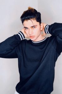 famous Indian Tiktok Star Lucky dancer posing with his blue eyes and black shirt