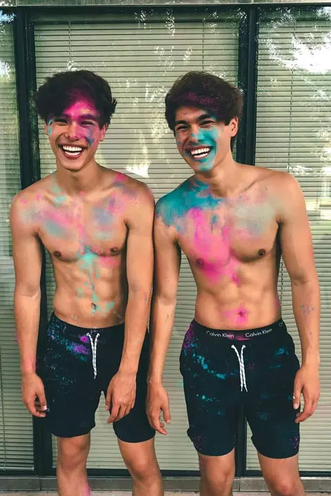 The stokes twins shirtless posing for picture after playing holi