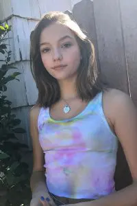 Jayden bartels wearing colourful top and necklace