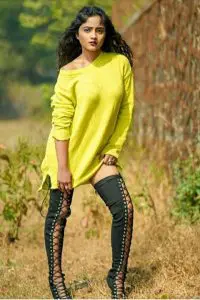 Nisha Guragain wearing black stocking and long yellow shirt