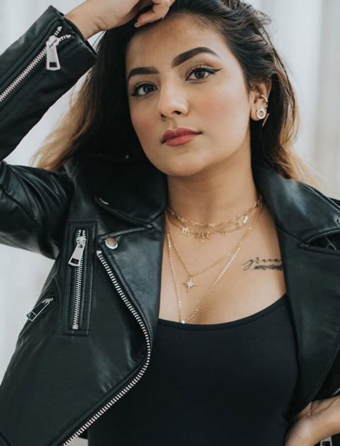Mrunal Panchal in black dress and jacket and visible tatto on her chest