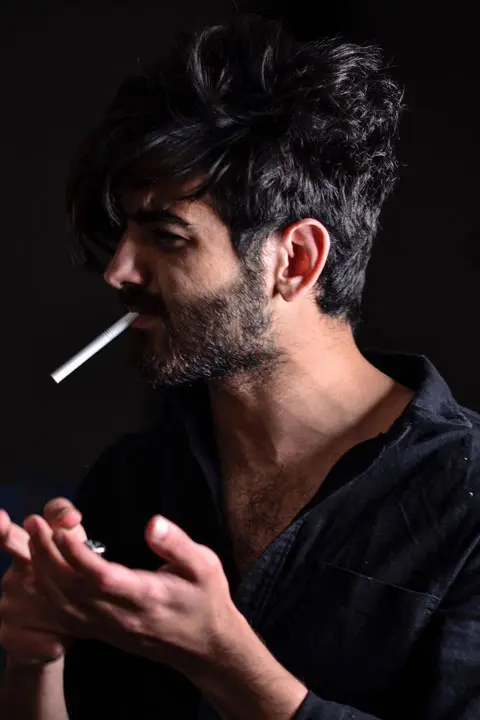 Umer Fayyaz Butt in black shirt and cigarette in mouth