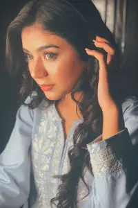 Areeka Haq posing with her beautiful green eyes and blue shirt
