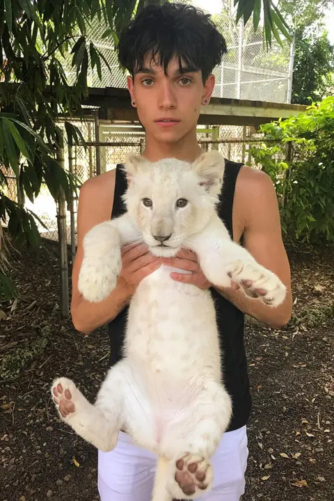Lucas Dobre playing with baby tiger