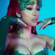 Cardi B cosplaying poison Ivy perfectly. She looks amazing in red hair and red nails. Her body is covered by leaves only.