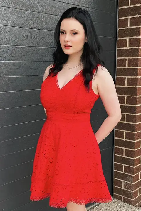 Hayley Stewart is looking at the camera and posing for a picture in red dress and open hair.