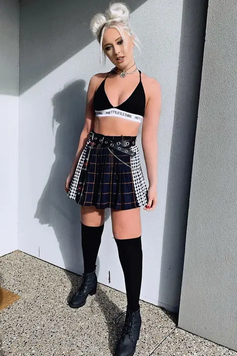 Kaytlyn Stewart in black strap blouse and black skirt. She is rocking her goth look with her white hair twin tails