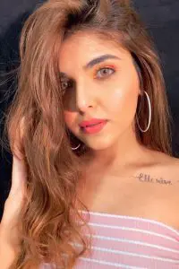 Ashi Khanna looking stunning with her green eyes, red lipstick and pink top. She is showing her tattoo on her shoulder.
