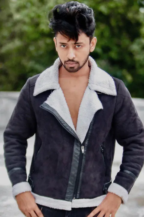 Sohail Shaikh posing with serious intense look camera. He is shirtless and is wearing jacket