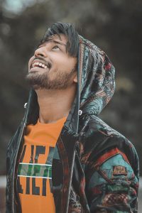 famous Indian Tiktok Star Sohail Shaikh enjoying and being happy while looking up. We can see his perfect jawline