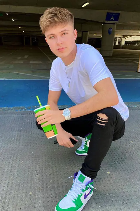 HRVY in green jogger and drinking his favorite drink