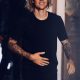 Justin Bieber is giving smile and wearing full black dress