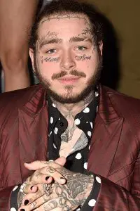 Post Malone in black dotted shirt and wearing mehron coat