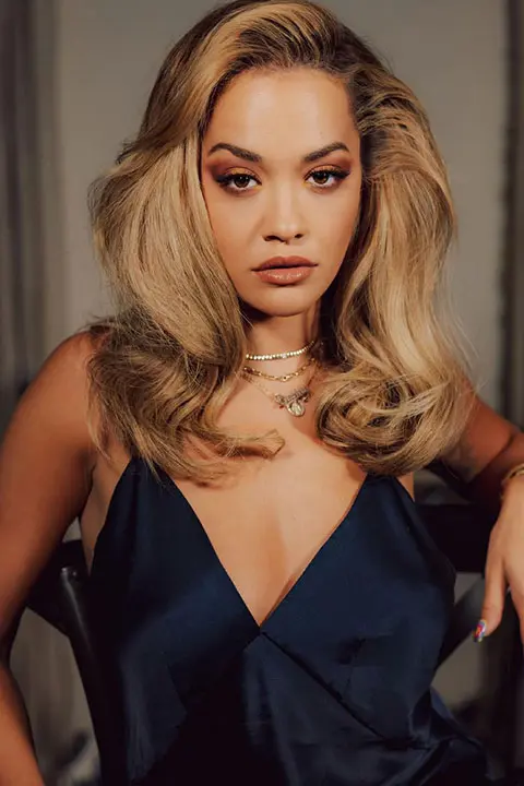 Rita Ora is looking hot in blue sleeveless dress and brown open hair.
