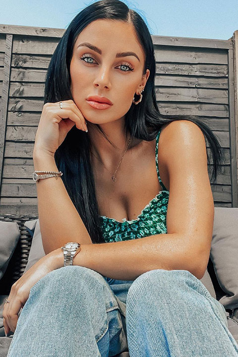 Cally Jane Beech in green blouse and blue jeans.