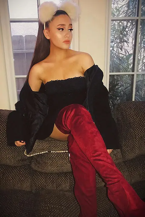 Paige Niemann Doppelganger of Ariana Grande in black shirt and red long socks