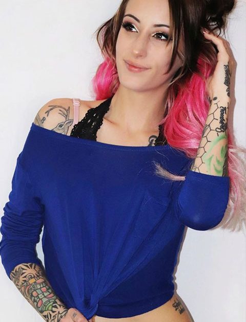 Sarah Janeczko in blue top and pink bra