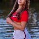 Zoe Jakaj is standing near lake and she is looking beautiful in red blouse.