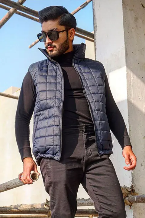 Arib Abbas posing in black clothes and blue jacket