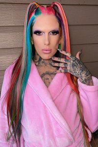 Jeffree star in rainbow color hairs and wearing shower towel
