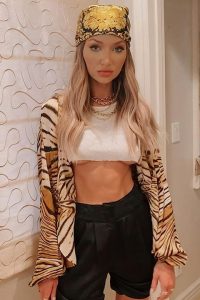 Erika Costell is looking pretty in white blouse and black shorts.