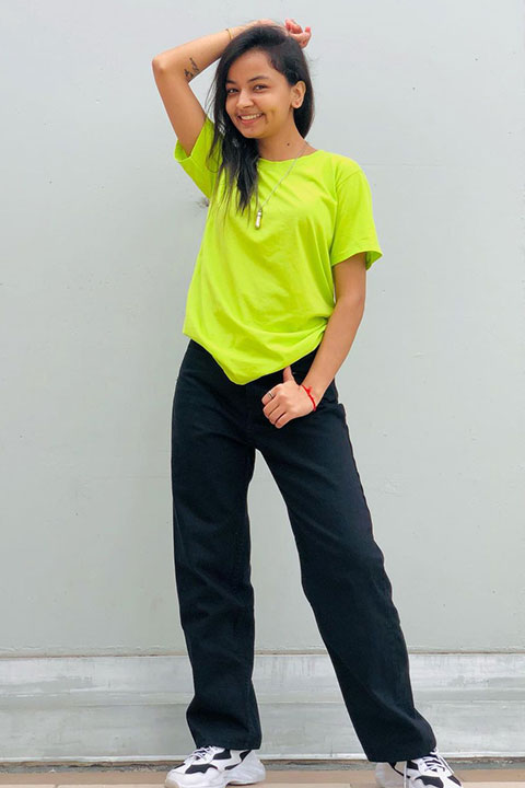 Mamta Acharya smiling in green tshirt and black pent