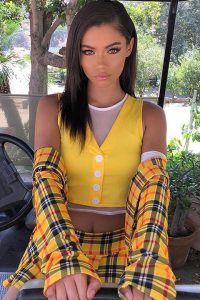 Audreyana Michelle sitting in car in yellow color dress