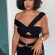 Jordyn Woods is beautifully posing for a picture in black dress.