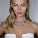 Karlie Kloss is looking beautiful in white dress and the chains in her neck are looking awesome.