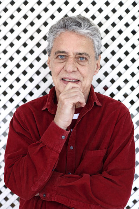 Chico Buarque Is looking elegant in red shirt.